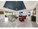 Cozy living room featuring tile floors, comfortable seating, and a tray ceiling with recessed lighting at 1219 Victoria Hills N Dr, Deland, FL 32724