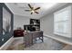 Bright office space with a ceiling fan, large window, built-in bookshelves, and stylish desk at 1219 Victoria Hills N Dr, Deland, FL 32724