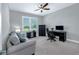 This office features a ceiling fan, large window, and desk with computer at 1219 Victoria Hills N Dr, Deland, FL 32724