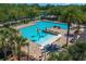 Resort-style community pool area with palm trees, splash area, and plenty of lounge seating for residents at 1219 Victoria Hills N Dr, Deland, FL 32724