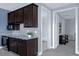 Stylish wet bar with granite counters, perfect for entertaining, conveniently located near a full bathroom at 1219 Victoria Hills N Dr, Deland, FL 32724