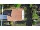 Birds eye view of house featuring brick roof, white siding, and greenery all around at 1222 Madelena Ave, Winter Springs, FL 32708