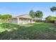 Wide backyard with a lawn and a screened-in porch at 1222 Madelena Ave, Winter Springs, FL 32708