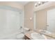 Clean bathroom featuring a shower and bathtub, tile flooring, and granite countertop sink at 1222 Madelena Ave, Winter Springs, FL 32708