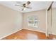 Bright bedroom features a ceiling fan, wood floors, and a sliding door closet at 1222 Madelena Ave, Winter Springs, FL 32708