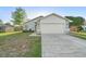 Beautiful home featuring a two-car garage, manicured lawn and lovely landscaping at 1222 Madelena Ave, Winter Springs, FL 32708