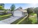 Well-maintained exterior of a modern home with a spacious two-car garage and a long driveway at 1222 Madelena Ave, Winter Springs, FL 32708
