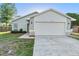 Beautiful home featuring a two-car garage, manicured lawn and lovely landscaping at 1222 Madelena Ave, Winter Springs, FL 32708
