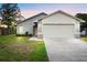Beautiful home featuring a two-car garage, manicured lawn and lovely landscaping at 1222 Madelena Ave, Winter Springs, FL 32708
