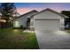 Charming single-story home features a two-car garage and well-maintained front lawn at 1222 Madelena Ave, Winter Springs, FL 32708