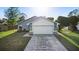 Inviting single-story home showcasing a spacious driveway, a two-car garage, and a neatly manicured lawn at 1222 Madelena Ave, Winter Springs, FL 32708