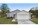 Attractive single-story residence with a two-car garage, complemented by lush greenery and a well-kept lawn at 1222 Madelena Ave, Winter Springs, FL 32708
