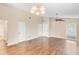 Expansive living room showcases hardwood floors, ceiling fan, and multiple entry points at 1222 Madelena Ave, Winter Springs, FL 32708