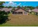 Aerial view of the home's exterior featuring a screened in porch and a well-maintained backyard at 133 Wood Ibis Ct, Daytona Beach, FL 32119