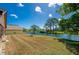 Backyard with a pond view provides serene outdoor living with mature trees at 133 Wood Ibis Ct, Daytona Beach, FL 32119