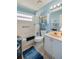 Well-lit bathroom with blue accents, a vanity, a toilet, and a shower/bathtub combo at 133 Wood Ibis Ct, Daytona Beach, FL 32119
