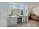 Primary bathroom with double sink vanity and tons of counter space is steps from main bedroom at 133 Wood Ibis Ct, Daytona Beach, FL 32119