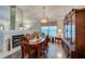 Warm dining room with fireplace, wood floors, and ample lighting from large windows at 133 Wood Ibis Ct, Daytona Beach, FL 32119