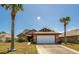 Charming single-story home featuring a two-car garage, brown-colored trim, and a well-maintained front yard at 133 Wood Ibis Ct, Daytona Beach, FL 32119