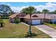 Charming single-story home with a two-car garage, mature landscaping, and a well-manicured lawn at 133 Wood Ibis Ct, Daytona Beach, FL 32119