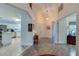 Inviting foyer featuring tile flooring, double entry doors, and an open view into the modern kitchen at 133 Wood Ibis Ct, Daytona Beach, FL 32119