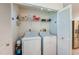 Organized laundry room closet featuring a full sized washer and dryer at 133 Wood Ibis Ct, Daytona Beach, FL 32119