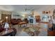 Comfortable living room with leather seating, fireplace, and open layout to dining area at 133 Wood Ibis Ct, Daytona Beach, FL 32119