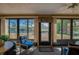 Bright sunroom with lake views, comfortable seating, and natural light at 133 Wood Ibis Ct, Daytona Beach, FL 32119
