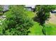 Lush green lawn, mature trees, and inviting swimming pool in this aerial view of property at 150 Lake Charles Rd, Deland, FL 32724