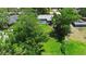 Expansive lot boasts mature trees, lush lawn, and inviting pool area, captured from above at 150 Lake Charles Rd, Deland, FL 32724