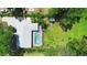 Aerial view of the property featuring a pool, manicured lawn, and privacy landscaping at 150 Lake Charles Rd, Deland, FL 32724