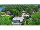 Aerial view of home featuring a sparkling pool, well-maintained landscaping, and lush trees for privacy at 150 Lake Charles Rd, Deland, FL 32724