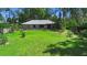 Well-manicured backyard showcases a charming home with mature trees offering a serene and private outdoor space at 150 Lake Charles Rd, Deland, FL 32724