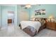 Comfortable bedroom features a ceiling fan, artwork, and ensuite bathroom access at 150 Lake Charles Rd, Deland, FL 32724