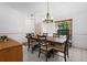 Open dining area with a wooden table, seating for six, and a large window providing natural light at 150 Lake Charles Rd, Deland, FL 32724