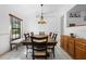 Bright dining room featuring modern lighting, a large window, and a stylish dining table set for Gathering meals at 150 Lake Charles Rd, Deland, FL 32724