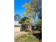 Charming home exterior with beautiful yellow flowering tree and well-maintained yard at 150 Lake Charles Rd, Deland, FL 32724