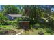 Serene home with lush landscaping, stone pathways, and private backyard area at 150 Lake Charles Rd, Deland, FL 32724