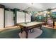 Large billiards room with a pool table, room for seating, and plenty of wall decor and custom lighting at 150 Lake Charles Rd, Deland, FL 32724