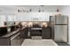 Modern kitchen features stainless steel appliances, white upper cabinets and dark lower cabinets for contrast at 150 Lake Charles Rd, Deland, FL 32724