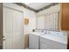 A laundry room with a full size washer and dryer and lots of natural light from the window at 150 Lake Charles Rd, Deland, FL 32724