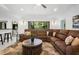 Spacious living room with a large sectional sofa, a view to the backyard and access to the breakfast bar at 150 Lake Charles Rd, Deland, FL 32724