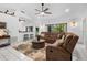 Inviting living room boasts a plush sectional sofa, fan and open layout connecting to the breakfast bar at 150 Lake Charles Rd, Deland, FL 32724