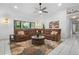 Cozy living room with comfortable brown sectional sofa, neutral rug and large window overlooking the yard at 150 Lake Charles Rd, Deland, FL 32724