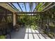Inviting covered patio area with iron benches, stone floors, and lush landscaping at 150 Lake Charles Rd, Deland, FL 32724