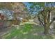 Private backyard with a lush lawn, mature trees offering shade, and a serene outdoor space at 1504 Ginger Snap, Deland, FL 32720