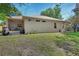 Backyard featuring a well-maintained lawn, covered patio, and beautiful landscaping at 1504 Ginger Snap, Deland, FL 32720