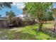 Backyard featuring a well-maintained lawn, mature trees and a wooden privacy fence at 1504 Ginger Snap, Deland, FL 32720