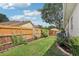 Grassy backyard area features a wooden privacy fence, garden beds and a lush lawn at 1504 Ginger Snap, Deland, FL 32720