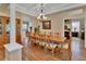 Elegant dining room features a coffered ceiling, chandelier, and wood floors at 1504 Ginger Snap, Deland, FL 32720